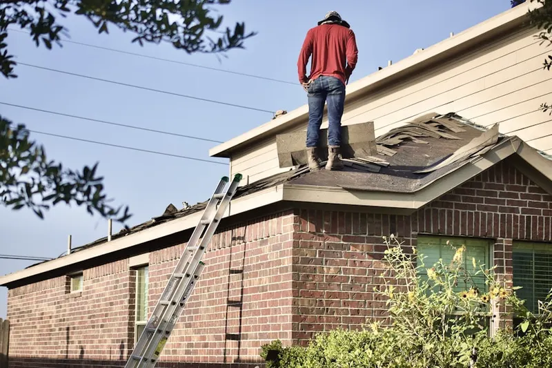 Professional roofer working on a residential roof in Puddle Town
